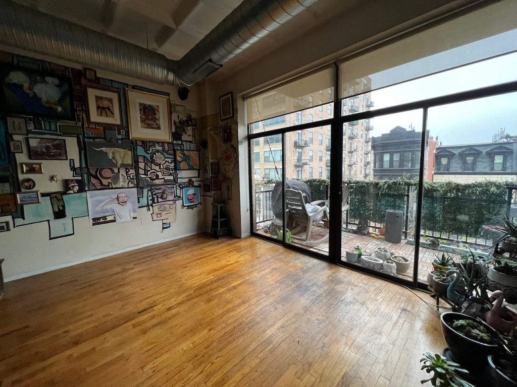 Floor-to-ceiling windows and hardwood floors in a Chicago loft