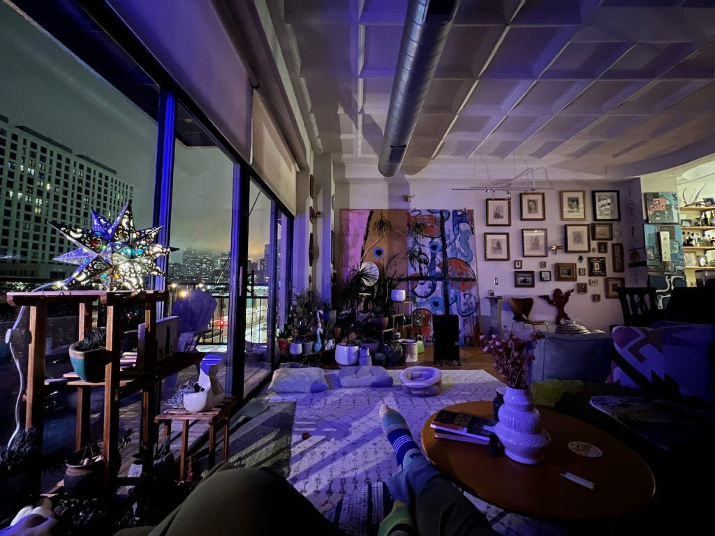 Living room with skyline views at dusk