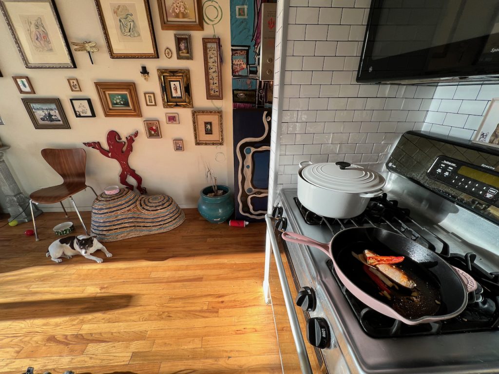 Kitchen with gas range and gallery wall