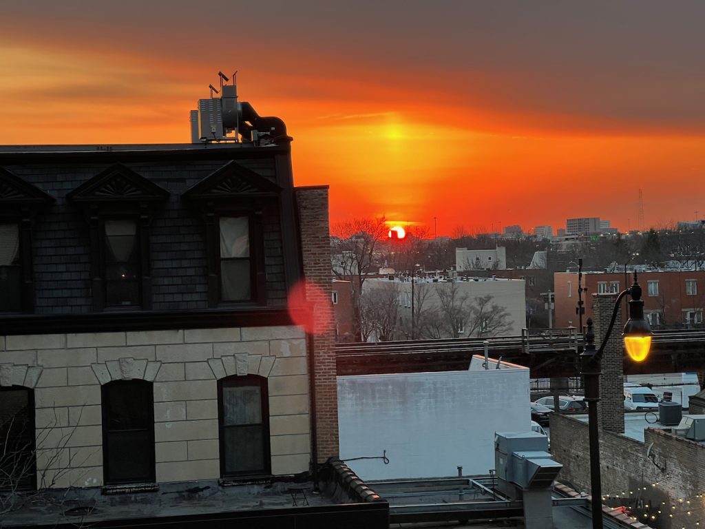 Sunset over Chicago rooftops from a west-facing South Loop condo