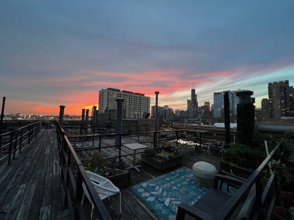 Rooftop deck at sunset overlooking downtown Chicago