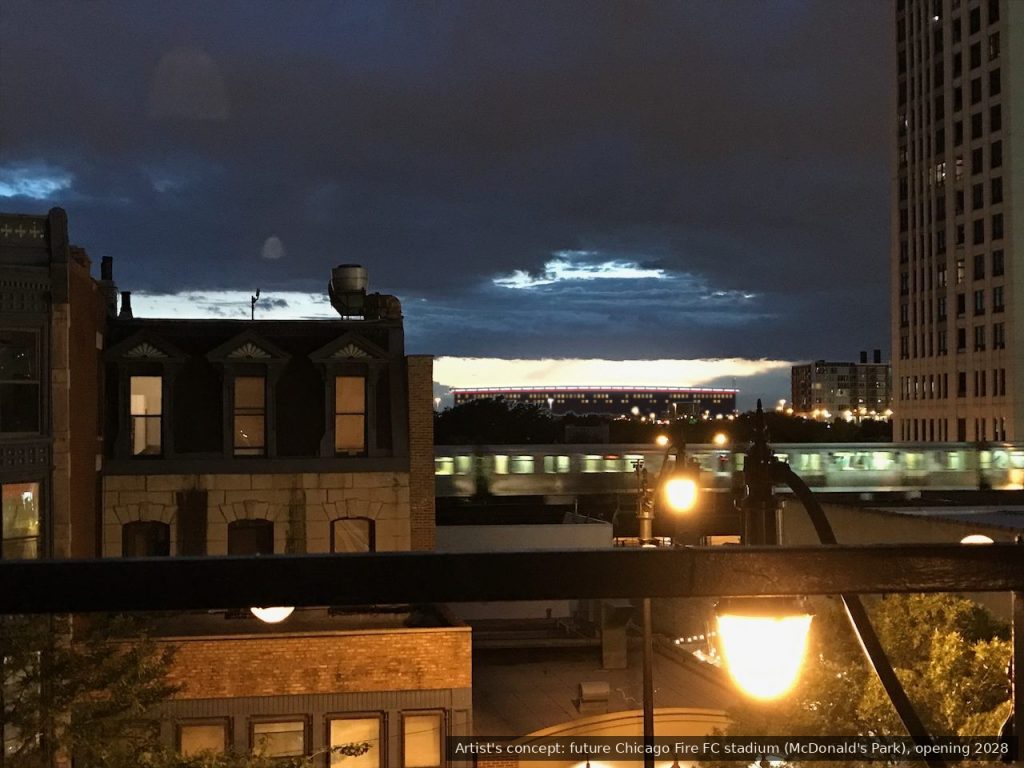 Artist's concept of the future Chicago Fire FC stadium lit at night, seen from the condo balcony